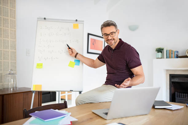 istock Teacher explaining during online lesson on video call from home 1319763459