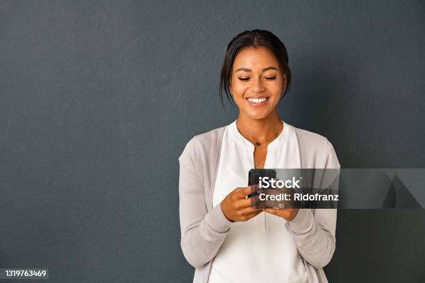 Happy African American Woman Using Smartphone Stock Photo - Download Image Now - Women, One Woman Only, Mobile Phone