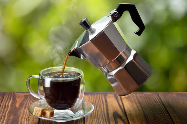 istock espresso pouring from flying geyser coffee maker into cup 1319763750