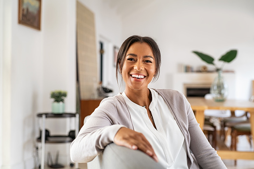 Happy smiling mid woman relaxing at home