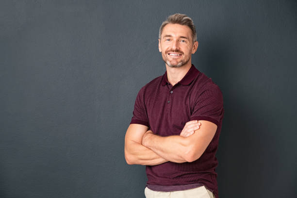 istock Happy middle aged man standing isolated on grey background 1319763847