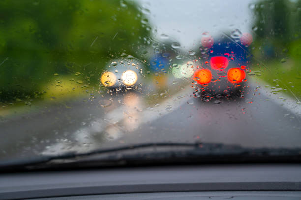 istock Car driving in the rain with drops on windshield 1319763856