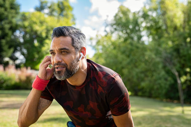 istock Mixed race mature man taking a break while jogging outdoor 1319764528