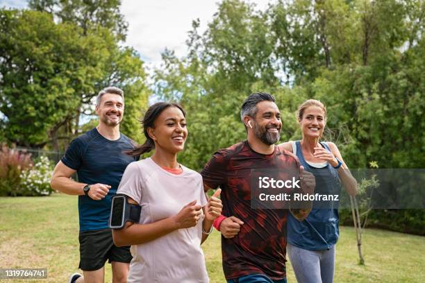 Mature People Jogging In Park Stock Photo - Download Image Now - Exercising, Running, Healthy Lifestyle