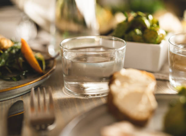 Transparent glass carafe or jug with water on a table