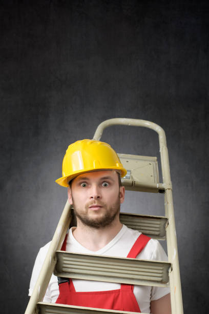 istock Portrait of a clumsy worker with ladder 1319765840