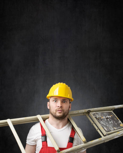 istock Portrait of a clumsy worker with ladder 1319765851
