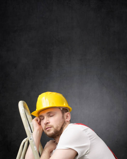 Portrait of a lazy worker with ladder Lazy construction worker sleeping on a ladder lazy construction laborer stock pictures, royalty-free photos & images