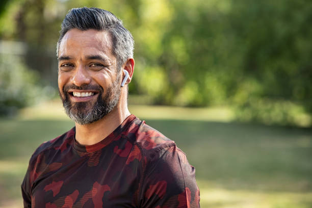 mid adult indian man smiling after running - indian ethnicity audio imagens e fotografias de stock