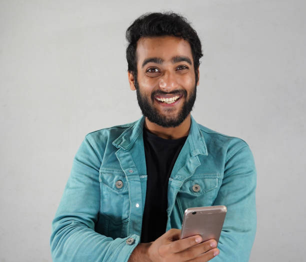 istock a man with a mobile watching news 1319769253