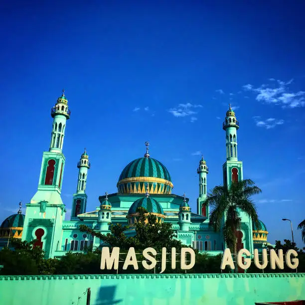 Beautiful green mosque in indonesia and blue sky for walpaper and background