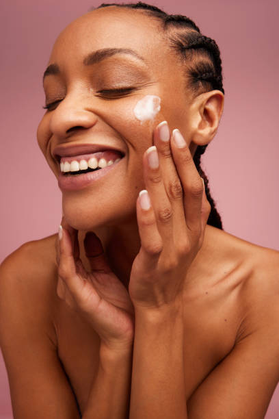 istock Beautiful woman applying cosmetic cream 1319772674