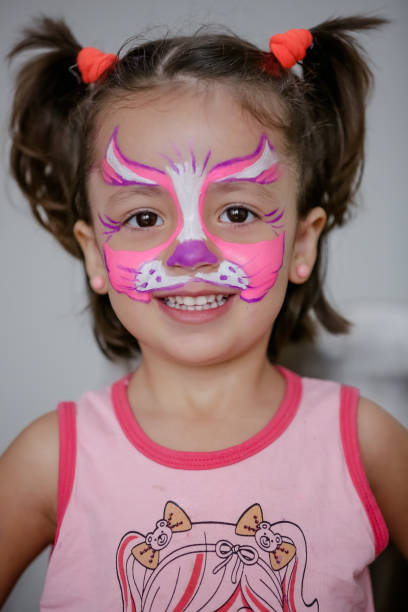 istock Child in cat costume with face painting. 1319773328