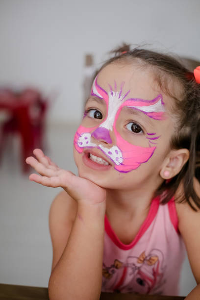 istock Child in cat costume with face painting. 1319773331