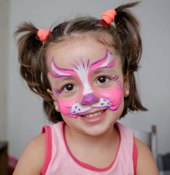 istock Child in cat costume with face painting. 1319773355