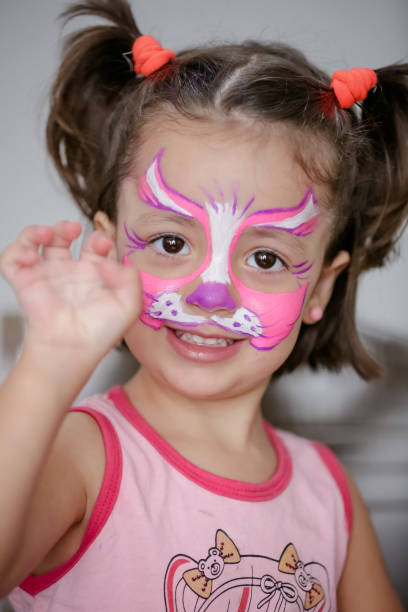 istock Child in cat costume with face painting. 1319773362