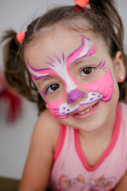istock Child in cat costume with face painting. 1319773368