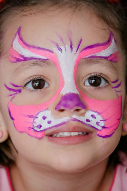istock Child in cat costume with face painting. 1319773379