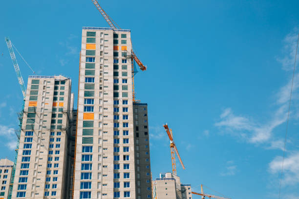 istock Modern apartment building with crane on construction site 1319774590