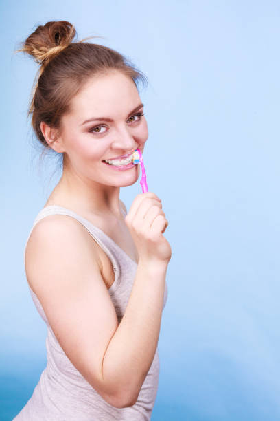 istock Woman brushing cleaning teeth 1319776975