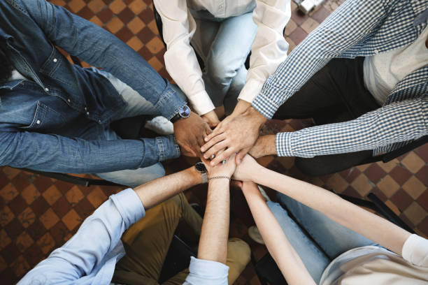 istock Top view of diverse people hands holding together in circle, hands stack 1319780482
