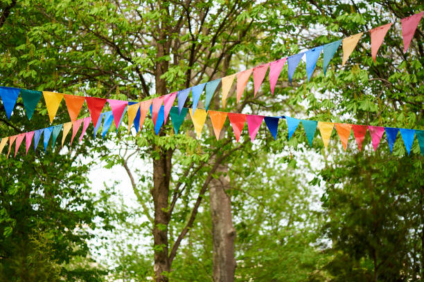 istock Colored flags on a background of green trees. 1319781101