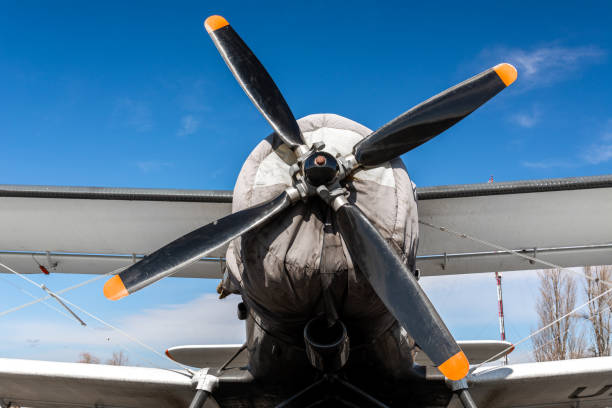 istock Light single-engine airplane front view: propeller with four blades, wing and wheels 1319781700