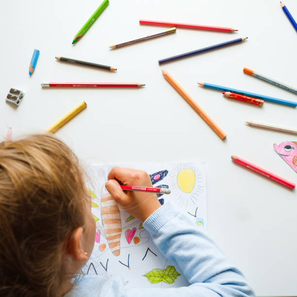 istock Elementary school girl draws with pencils at home. 1319781836