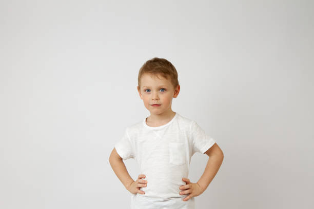 istock A pre-school boy with blue eyes stands with his hands on his hips. 1319781983