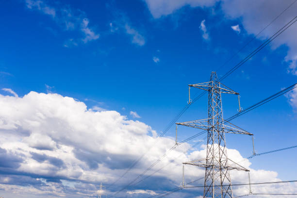 istock Low angle view of electricity pylon carrying high voltage energy 1319782162