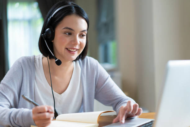 istock Homeschool Caucasian cute young girl student learning virtual internet online class from school teacher by remote meeting due to Covid pandemic. Male teacher teaching math calculus by using whiteboard 1319783198