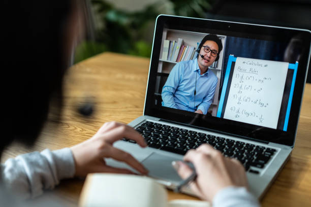 istock Homeschool Caucasian cute young girl student learning virtual internet online class from school teacher by remote meeting due to covid pandemic. Male teacher teaching math calculus by using whiteboard 1319783220