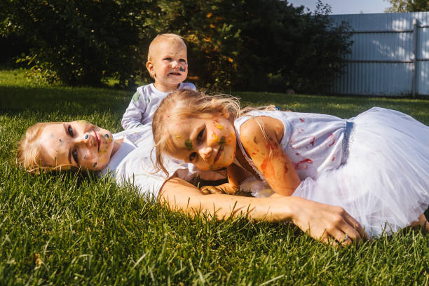 istock Happy painted mother with daughters in garden. 1319783484