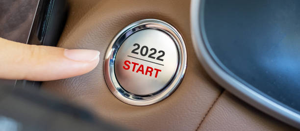 istock Finger press a car ignition button with 2022 START text inside modern electric automobile. New Year New You, resolution, change, goal, vision, innovation and planning concept 1319783575