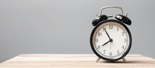 istock Vintage alarm clock on wooden table background and copy space for text. Activity, daily routine, morning, workout and Work life balance concept 1319785961