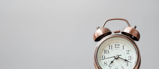 istock Vintage alarm clock on wooden table background and copy space for text. Activity, daily routine, morning, workout and Work life balance concept 1319786124