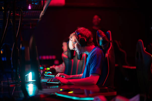 professional esports players at an online game tournament. the cyber team plays computers and trains - gamer imagens e fotografias de stock