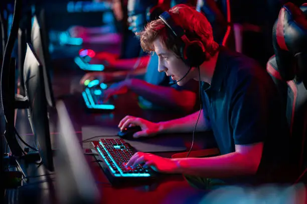 Photo of Professional esports players at an online game tournament. The cyber team plays computers and trains