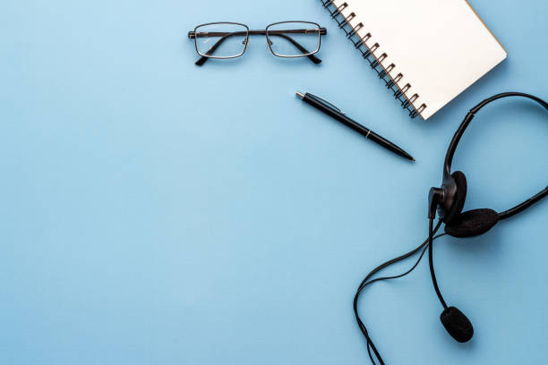 istock Voip headset on office desk. Call center support or customer service help 1319787996