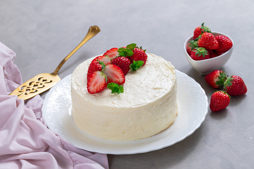 Delicious cheesecake with fresh strawberries without baking on a gray background