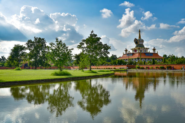 Reflection of a Buddhist temple on water at Lumbini, Nepal, the birth place of Buddha Reflection of a Buddhist temple on water at Lumbini, Nepal, the birth place of Buddha lumbini nepal photos stock pictures, royalty-free photos & images