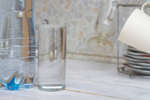 istock A glass full of clear water sits on the kitchen table. Copy space 1319790521
