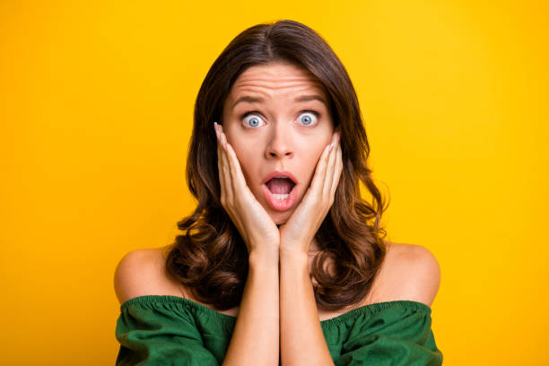 Photo of amazed scared terrified woman hold hands cheeks wear green off-shoulders blouse isolated on yellow color background Photo of amazed scared terrified woman hold hands cheeks wear green off-shoulders blouse isolated on yellow color background. women screaming surprise fear stock pictures, royalty-free photos & images