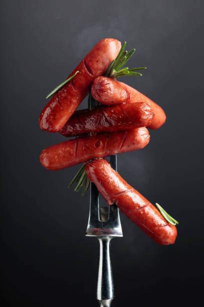 istock Small grilled sausages with rosemary. 1319793109