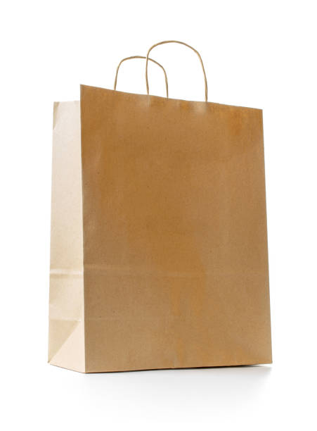 istock Brown paper bag texture. Kraft recycle package with empty blank space for design mockup isolated on white background. Delivery service concept. Copy space. Advertising area. 1319793393