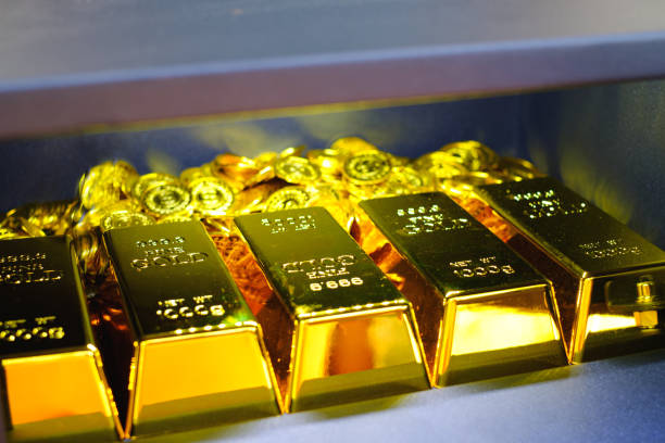 istock Steel safes box full of gold bar stack and coins 1319793409