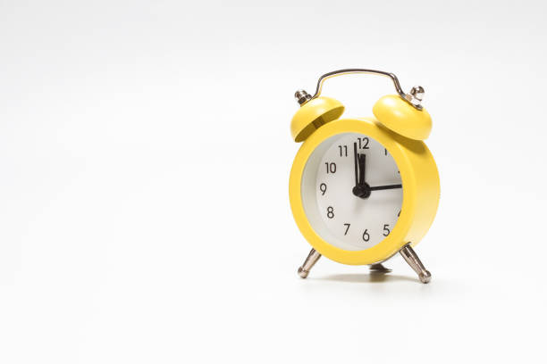 istock Yellow alarm clock isolated on a white. 1319794369