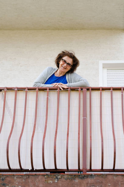istock Elderly lady smiling and looking at camera 1319794391