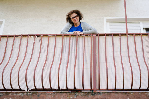 istock Elderly lady smiling and looking at camera 1319794412