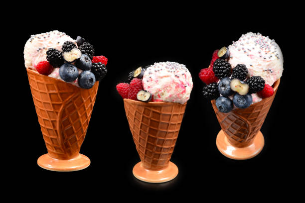 istock Ice cream with blueberries, blackberries and raspberries on a black background.  Copy space. 1319794450